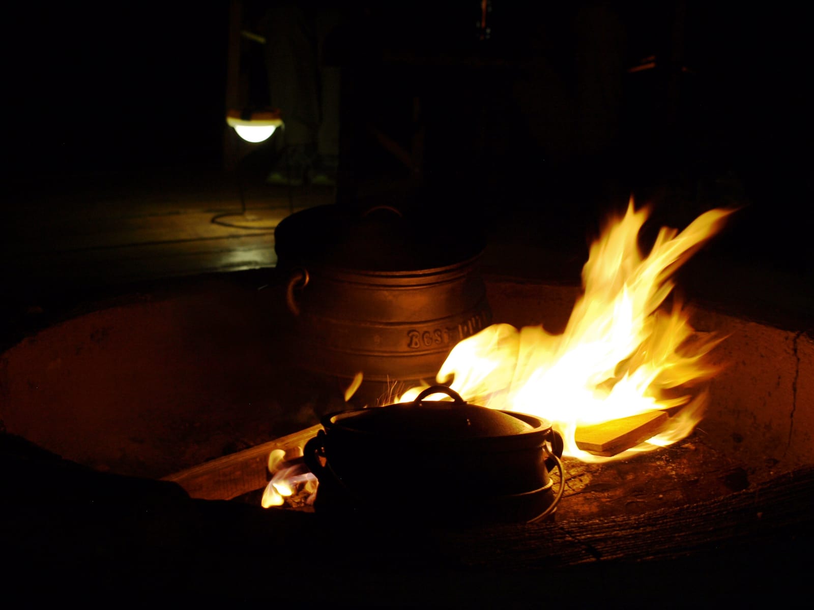 A campfire burning at a safari lodge in Akagera, Rwanda, after dark